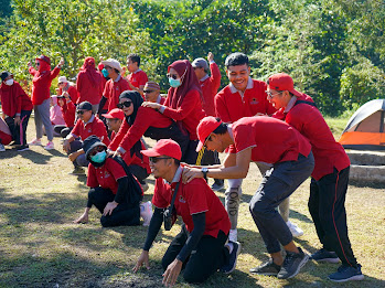 A group of people participating in various outbound activities, enjoying a fun and active environment.
