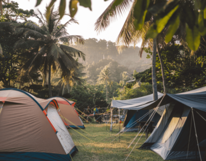 Beautiful place for camping and glamping.Adventurers exploring the rugged wilderness of Lombok, with tents in the background.